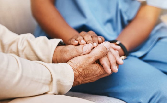 Doctor and patient holding hands through behavioral health patient journey