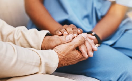 Doctor and patient holding hands through behavioral health patient journey