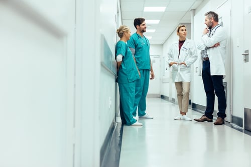 Doctors discussing how to solve the interoperability gap.