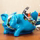 Breaking a piggy bank with a hammer