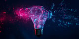 Light bulb with pink and blue lighting shattering, representing reimagining ideas about EHRs