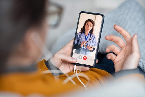 healthcare provider improving patient engagement with EHR software via telehealth on the patient’s mobile device