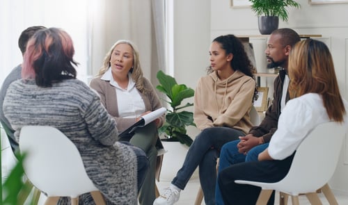 Counseling group with a group of diverse people in therapy for depression, stress, and anxiety.