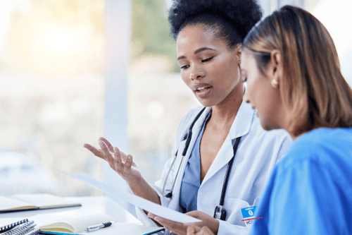 Two clinicians conferring with one another