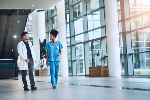 2 Clinicians in a hospital discussing EHR personalization