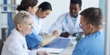 Healthcare leadership meeting in a board room in their hospital