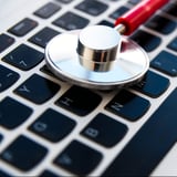 Stethoscope on a computer keyboard