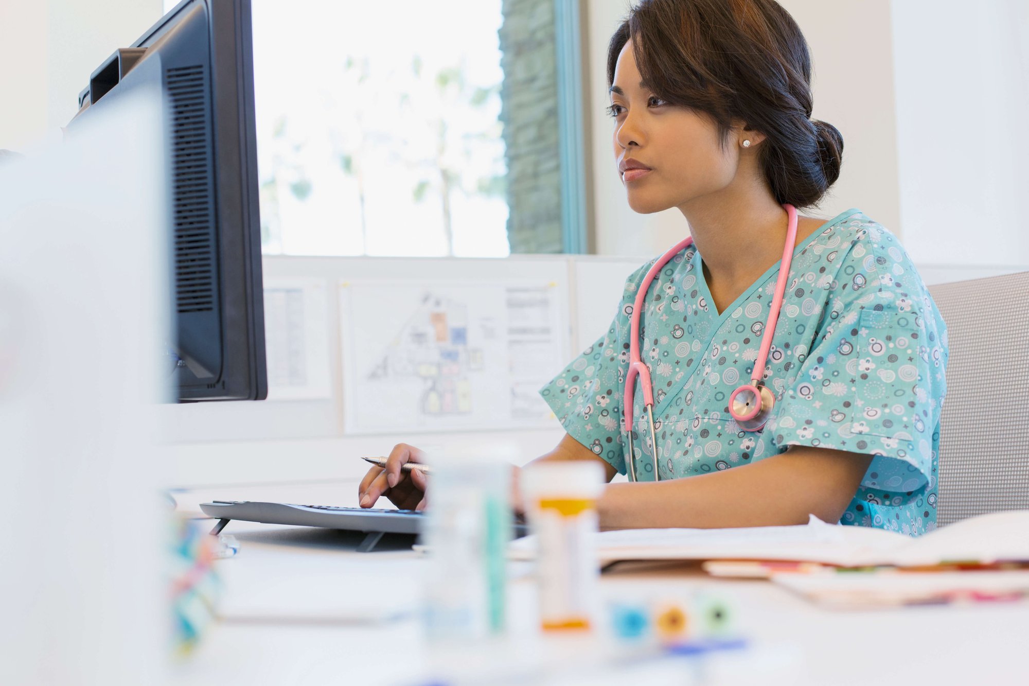 Female nurse using EHR after a successful EHR implementation