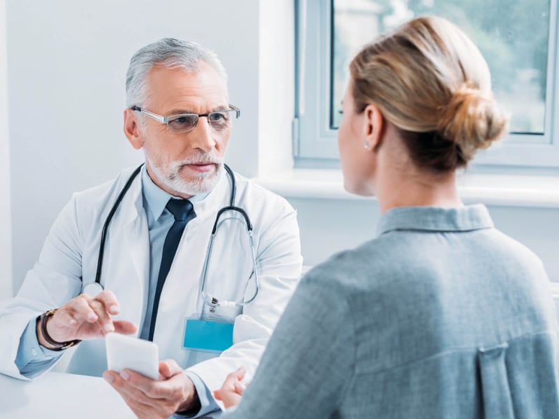 Doctor taking notes on mobile device using AVO Doctor taking notes on mobile device using AVO