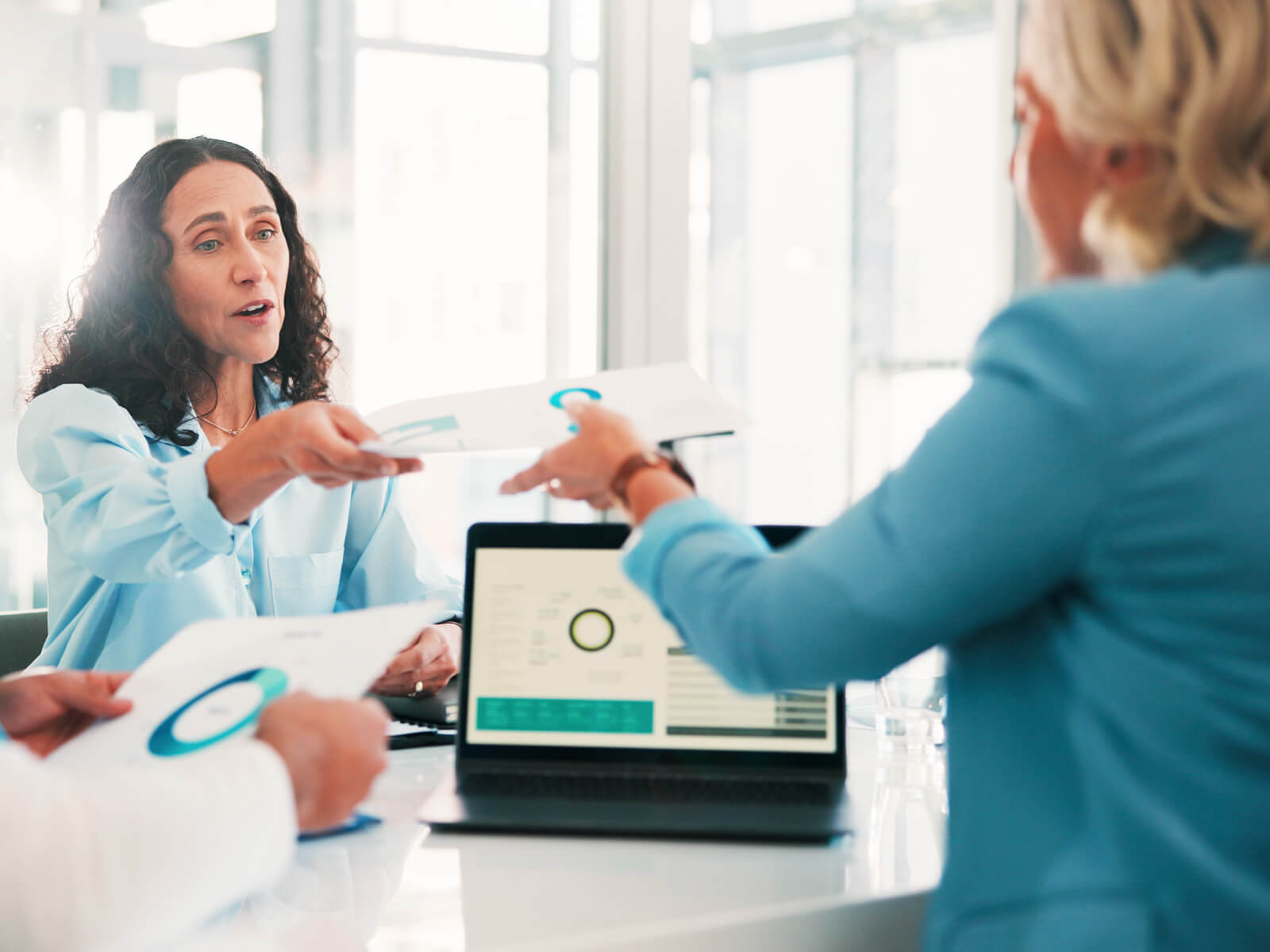 Healthcare administrators reviewing program documents and data reports together, representing the qualification criteria and requirements for rural health transformation funding