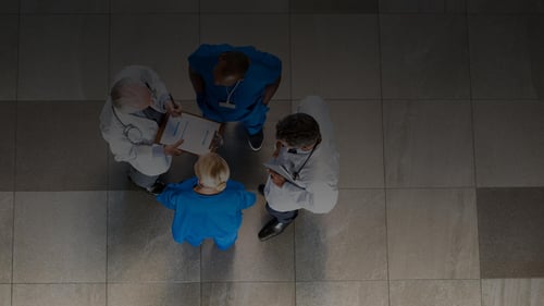 Team of doctors and nurses providing patient care in EHR 